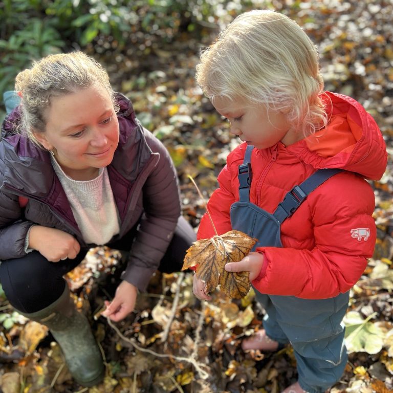 student holding a large leaf