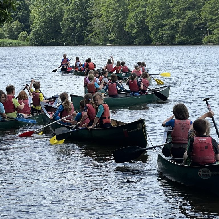 students in kayaks