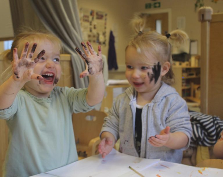 students with paint on their hands